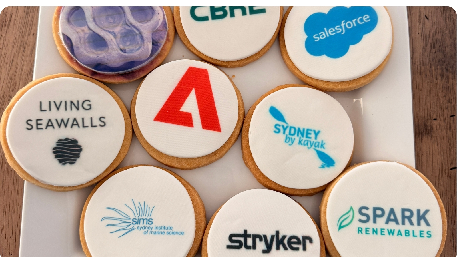 Biscuits iced with the logos of corporate partners alongside the Sydney By Kayak logo.