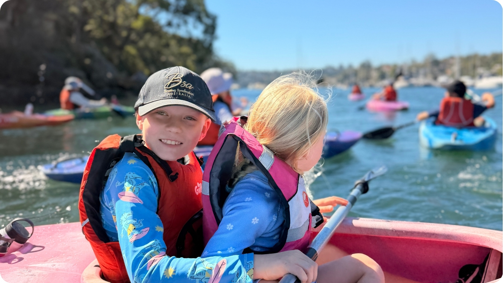 Families and children paddling together on a community Bushcare paddle.